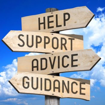 Wooden signpost with four arrows - help, support, advice, guidance - great for topics like frequently asked questions, customer support etc.